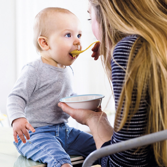 Mom feeding baby with a spoon